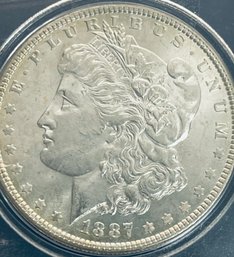 1887 MORGAN SILVER DOLLAR COIN - IN PLASTIC CASE