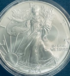 2004 SILVER AMERICAN EAGLE ONE OZT 99.9 PERCENT FINE SILVER ROUND COIN IN PLASTIC CAPSULE