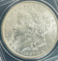1887 MORGAN SILVER DOLLAR COIN - IN PLASTIC CASE