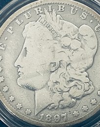 1897-O MORGAN SILVER DOLLAR COIN IN PLASTIC CAPSULE