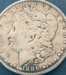1886 MORGAN SILVER DOLLAR COIN - RIM DAMAGE