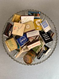 Assorted Vintage Matchbooks And Boxes From The U.S. And Abroad In A Cut Glass Bowl