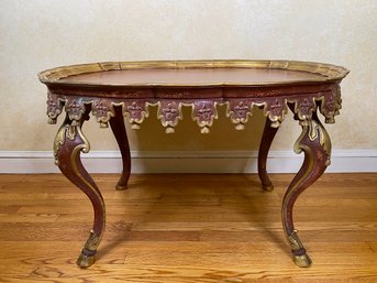 Italian Carved And Painted Oval Cocktail Table With Gold Gilt Trim