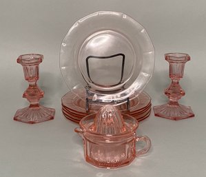 Group Of Pink Glass Tablewares: Candlesticks, Plates, Juice Reamer