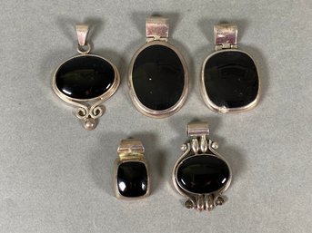 Collection Of Pendants With Black Stones Set In Sterling Silver Mounts