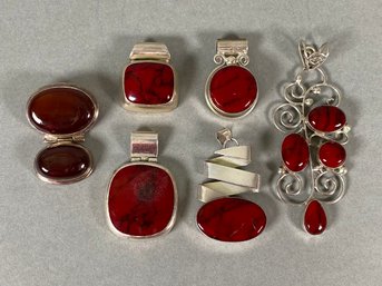 Collection Of Red Stone Pendants Set In Sterling Silver Mounts