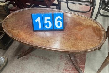 Mahogany Oval Top Coffee Table With Intricate Design Above Splay Legs