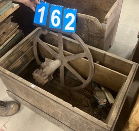 Old Wooden Crate With A Corn Husker Grinding Wheel Element