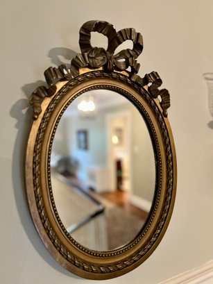 (HALL) ANTIQUE GOLD GILT OVAL WOOD MIRROR WITH CARVED RIBBON & BOW DETAIL -31' BY 15'