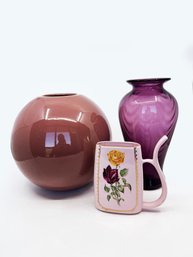 (55) THREE PURPLE DECORATIVE ITEMS - CERAMIC ROUND VASE, AMETHYST GLASS VASE & MYSTERY PORCELAIN PIECE