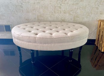 (E) OVAL TUFTED UPHOLSTERED OTTOMAN - IVORY COLOR, NEEDS SOME SPOT CLEANING - 46' BY 30' BY 19' HIGH