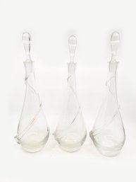 (C-35) COLLECTION OF THREE VINTAGE MATCHING GLASS DECANTERS - APPROX. 12' TALL - TWO HAVE EDGE CHIPS