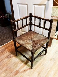 (BB-2) ANTIQUE WOOD AND STRAW CORNER CHAIR POSSIBLY FRENCH BOBBIN-28' X 17' X 27'