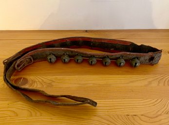 (U-211) ANTIQUE STRING OF SLEIGH BELLS ON WELL WORN LEATHER STRAP - 60' LONG