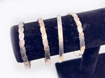 (A-86) COLLECTION OF FOUR VINTAGE STERLING SILVER BANGLE BRACELETS - DWT 37.23