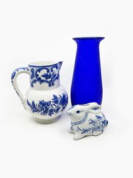 (A-61) THREE BLUE OBJECTS D'ARTE - CERAMIC BUNNY, UNMARKED VASE & TIFFANY DELFT PITCHER