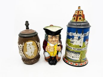 (A-79) TRIO OF TWO VINTAGE VILLEROY & BOCH BEER STEINS & A ROYAL DOULTON ENGLISH TOBY PITCHER - 6' -10'