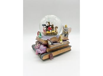 D-29 -DISNEY MUSICAL SNOW GLOBE - DUMBO, TINKERBELL ON BOOKS - PLAYS 'A DREAM IS A WISH YOUR HEART MAKES '- 8'