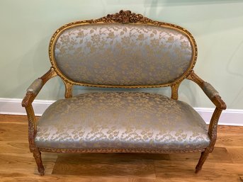 Antique Loveseat Featuring A Carved Wooden Frame With Intricate Detailing And Gold Finish