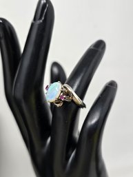 Lot 453 Stunning Blend Of Elegance And Allure 18 KARAT White Gold Opal With Ruby Ring-5 Grams