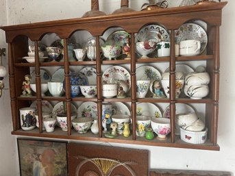 Collection Of Porcelain Tea Cups On Wall Shelf