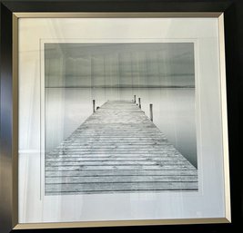 Black And White Photograph Framed Of A Pier With An Ominous Sky And Mountains In The Background. 28 X 28