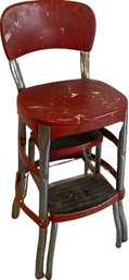 Red Cosco Utility Chair With Pullout Steps.  Shows Wear With Paint Marks. 24 High.