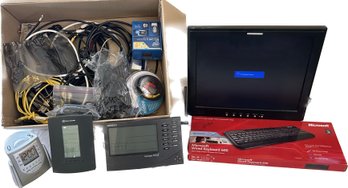 Assorted Cords, Liquid Video Monitor(17in), Microsoft Wired Keyboard, TIMEX Alarm Clock, & Weather Devices.