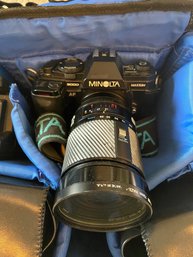 Minolita Camera With Showing Lens Cap, Camera Bag And Camera Accessories