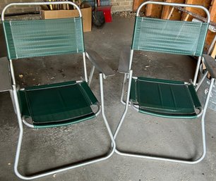 A Pair Of Aluminum Camping Chairs With Dark Green Mesh Seats/Backs