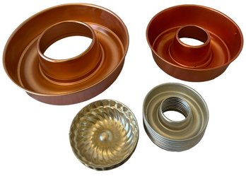 A Pair Copper Colored Jello Molds And 2 Mini Aluminum Molds