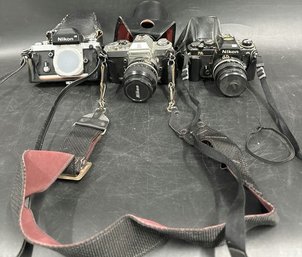 (3) Nikon Camera With Straps And Camera Lenses