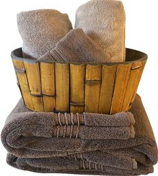 Two Brown Bath Towels, 2 Beige Hand Towels, 1 Brown Washcloth & Bamboo Style Basket.