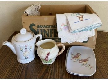 Wooden Box With Various Embroidered Napkins And Beautiful China Pieces