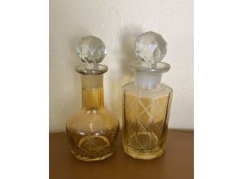 Two Small Glass Bottles With Round Cork Tops