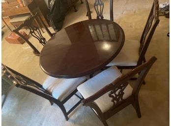 Classic Dark Wood Dining Room Table With 6 White Cushioned Chairs And A Leaf Extender.