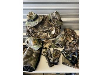 Assortment Of Hunters Gear. Camouflage Hats, Gloves, Head Covers And Hats, With A Cabelas Duffel Bag