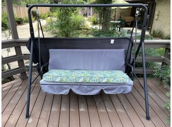 Metal Patio Swinging Bench With Extra Leaf Print Cushion And Black Canopy