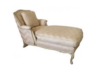 Lovely Chaise Lounge With Light Pink Fabric And Cream Colored Wood Base.