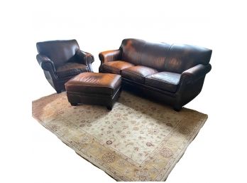 Brown Distressed Leather Couch In Great Condition With Chair And Ottoman. Area Rug Is Also Included