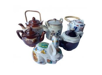 Lovely Array Of Ceramic Teapots With Simple And Unique Designs And An Adorable Bunny Figurine