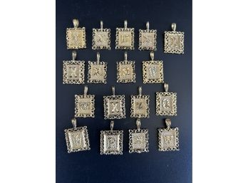 17 Gold Colored Necklace Charms With A Letter On Each One