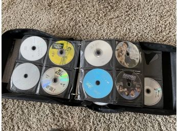 Collection Of DVDs And CDs In A Carrier Case. (B)