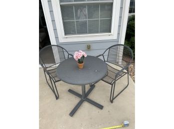 Small Black Metal Outdoor Table With  Two Chairs. Cute Decorative Flower Pot Included.