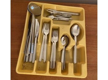 Lot Of Silverware With Spoons, Forks, And Knives In A Yellow Holder.