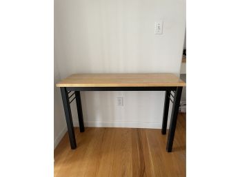 Small Wood And Black Table. Approx. 42X14X28 Inch.