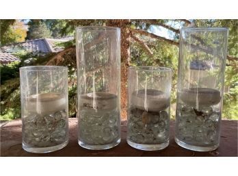 Set Of 4 Glass Jars Filled With White Gemstones And Candles Inside