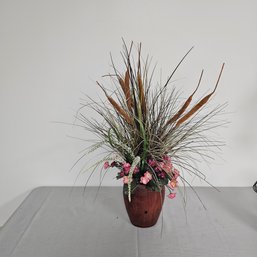 Wooden Vase Filled With A Variety Of Artificial Flowers