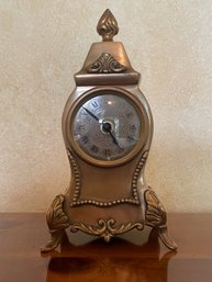 Small Reproduction Of French Clock With Cast Brass Footed Case, Aged Finish, & Ornate Face B4