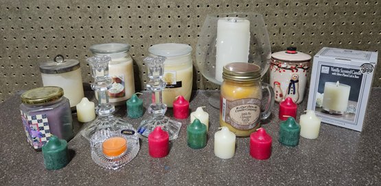 An Assortment Of Candles And Candle Holders